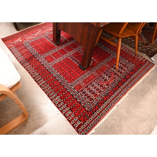 168 - A Persian Turkoman tile design red ground rug, 186 x 126 cm