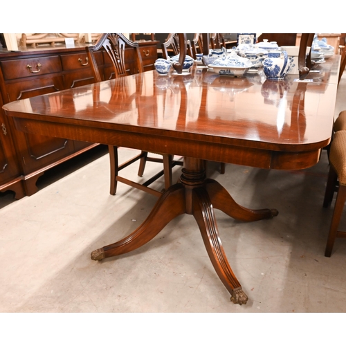 172 - A large reproduction mahogany twin pedestal extending dining table in Regency style with three optio... 