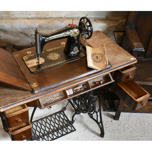 188 - The Singer Manufacturing Co. mahogany and cast iron sewing table with integrated fold away dewing ma... 