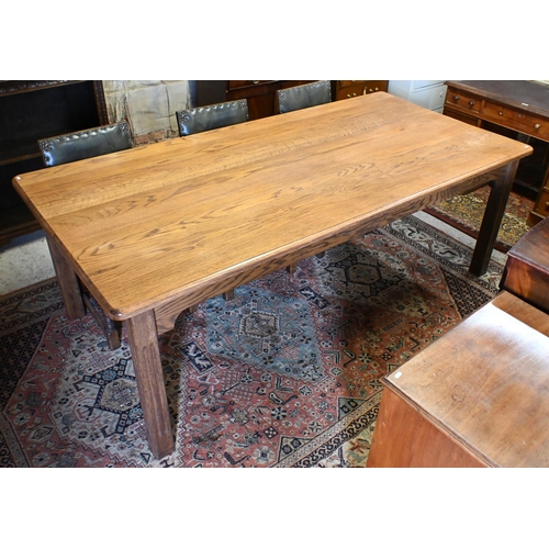 193 - A large oak dining table, the rectangular top with moulded edge raised on fluted square supports, 22... 