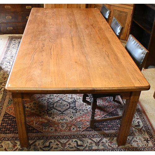 193 - A large oak dining table, the rectangular top with moulded edge raised on fluted square supports, 22... 