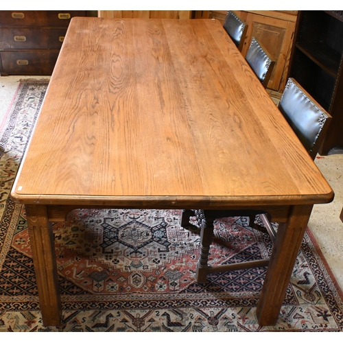 193 - A large oak dining table, the rectangular top with moulded edge raised on fluted square supports, 22... 