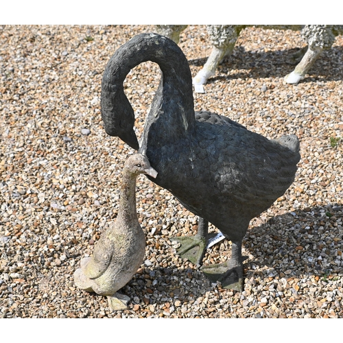 202 - A green bronze patinated garden geese sculpture to/w a small cast stone goose, 58 cm high, a/f (2)