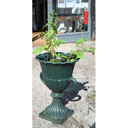 21 - A pair of cast iron twin-handled urn planters, in green paint finish, 63 cm high