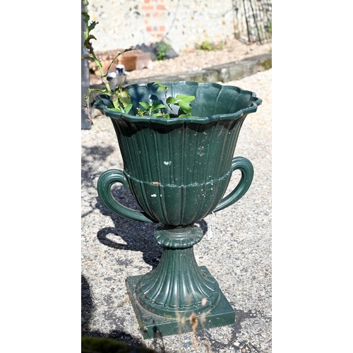 21 - A pair of cast iron twin-handled urn planters, in green paint finish, 63 cm high