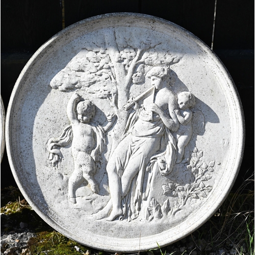 22 - A pair of circular reconstituted stone plaques cast in relief with classical figures, 52 cm dia.