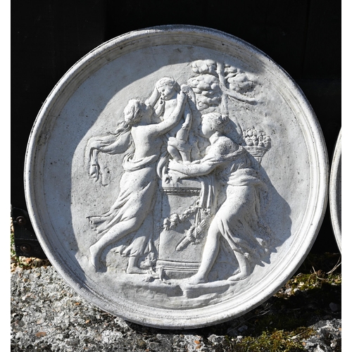 22 - A pair of circular reconstituted stone plaques cast in relief with classical figures, 52 cm dia.