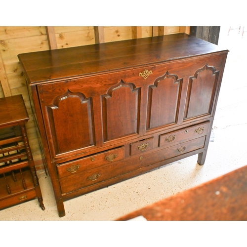 220 - An 18th century oak mule chest, now with four Arabic arch panelled fall front, over an arrangement o... 