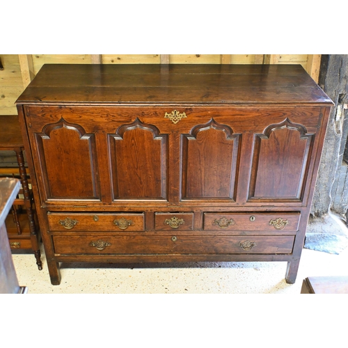 220 - An 18th century oak mule chest, now with four Arabic arch panelled fall front, over an arrangement o... 