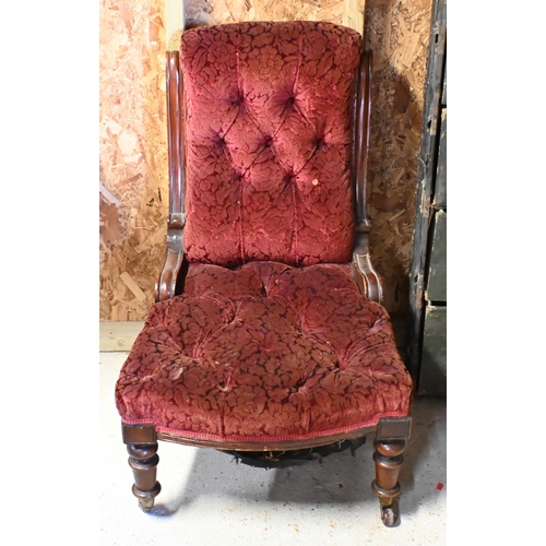 226 - A Victorian walnut framed button back floral fabric covered chair, on ceramic casters