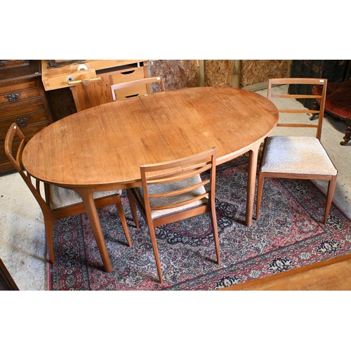 231 - A mid-century teak extending Mackintosh dining table, with integral butterfly leaf, to/with four cha... 