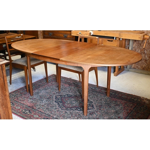 231 - A mid-century teak extending Mackintosh dining table, with integral butterfly leaf, to/with four cha... 