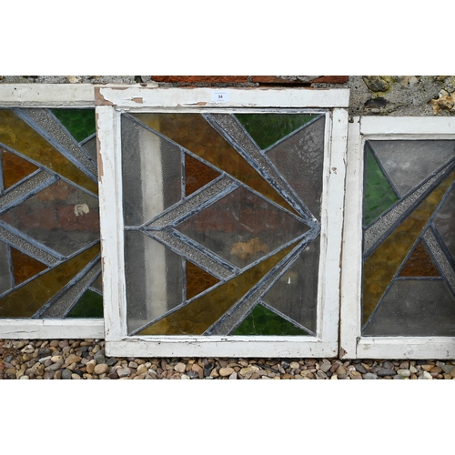 34 - Five various geometric stained and leaded glass panels within painted wooden frames (5)