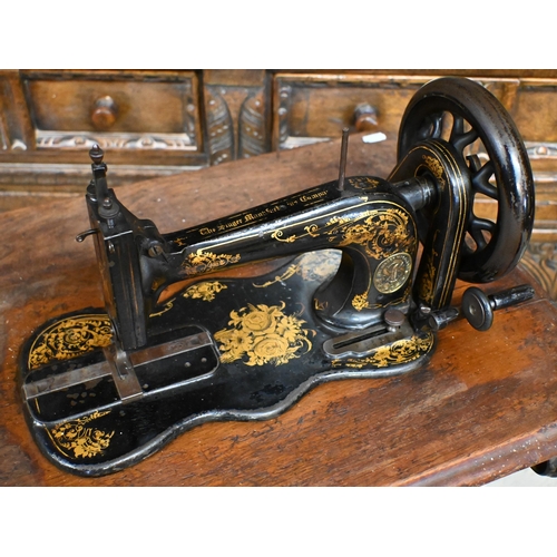 48 - # A vintage Singer treadle sewing machine table with cast iron base and machine box cover, a/f