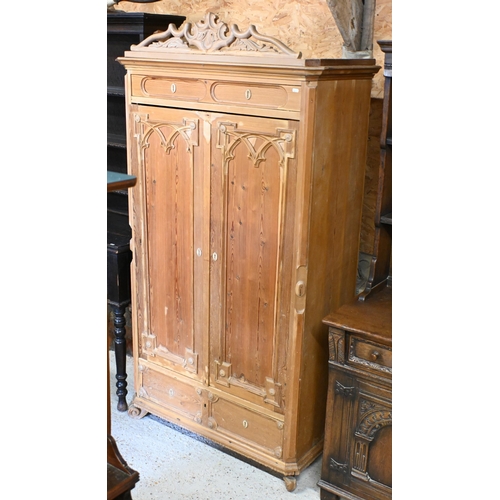 49 - An antique stripped pine wardrobe with gothic moulded door, on scroll feet, 100 cm x 49 cm x 188 cm ... 