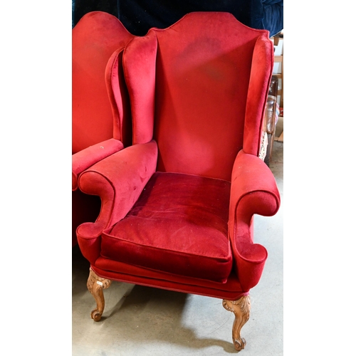 506 - A pair of walnut framed wingback armchairs, burgundy dralon upholstery and acanthus carved front leg... 