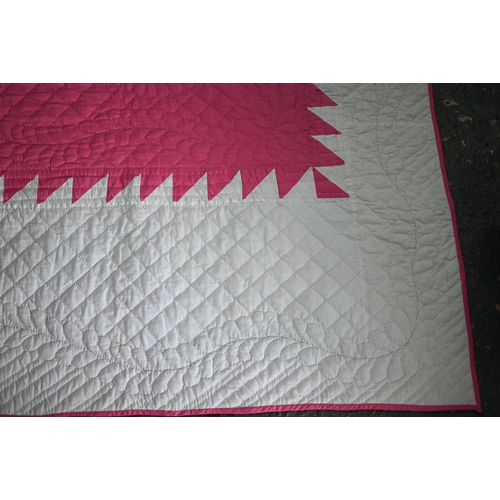 512 - A cerise and white geometric design quilted comforter/quilt, 240 cm x 210 cm