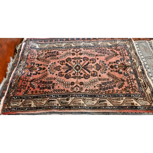 514 - A Persian Shiraz rug with central blue medallion on red ground within floral brown border to/w a Per... 