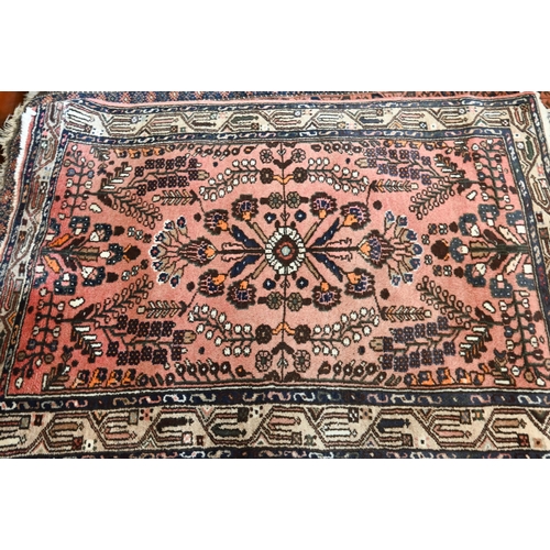 514 - A Persian Shiraz rug with central blue medallion on red ground within floral brown border to/w a Per... 