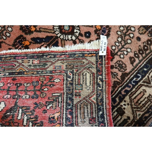 514 - A Persian Shiraz rug with central blue medallion on red ground within floral brown border to/w a Per... 