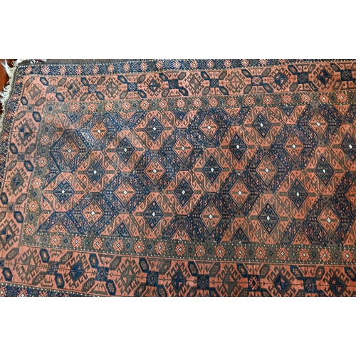 515 - A Persian Baluchi brown ground rug with repeating diamond design, 206 cm x 113 cm