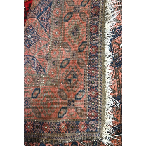 515 - A Persian Baluchi brown ground rug with repeating diamond design, 206 cm x 113 cm