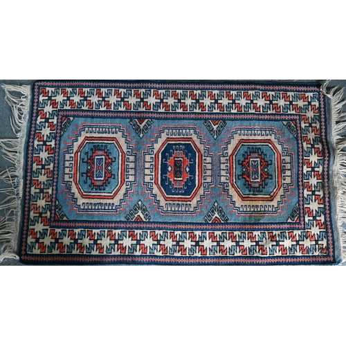 518 - A Turkish geometric design blue ground rug, 110 cm x 59 cm to/w a Pakistan Turkoman design reg groun... 