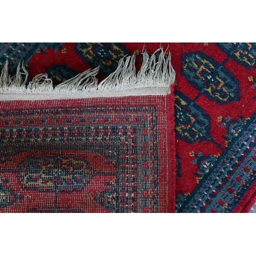 518 - A Turkish geometric design blue ground rug, 110 cm x 59 cm to/w a Pakistan Turkoman design reg groun... 