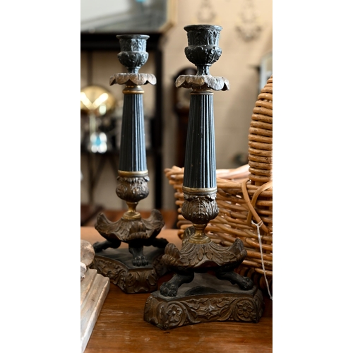 521 - A pair of Empire style bronze candlesticks on claw feet and triform bases, to/w a pair of plaster wa... 