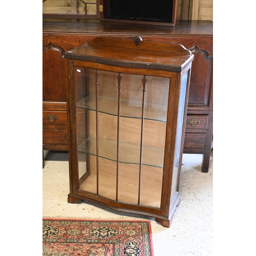 537 - An Arts & Crafts serpentine form glazed display cabinet, 73 cm x 31 cm x 108 cm h