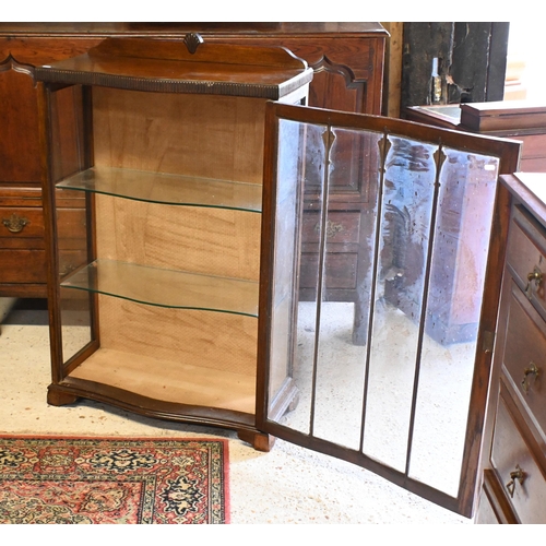 537 - An Arts & Crafts serpentine form glazed display cabinet, 73 cm x 31 cm x 108 cm h