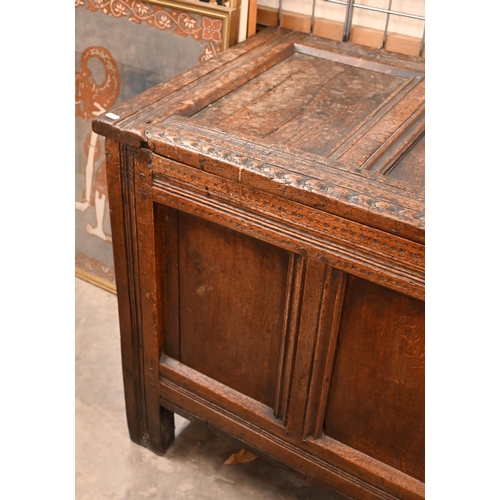 565 - A large antique panelled oak coffer, 144 cm w x 58 cm d x 72 cm h