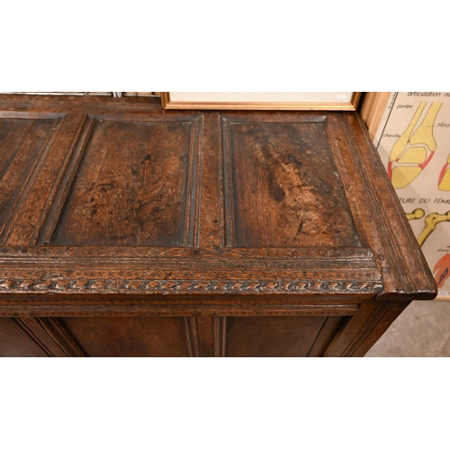 565 - A large antique panelled oak coffer, 144 cm w x 58 cm d x 72 cm h