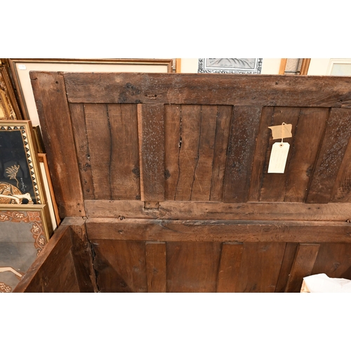 565 - A large antique panelled oak coffer, 144 cm w x 58 cm d x 72 cm h