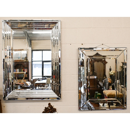 567 - Two contemporary wall mirrors (larger with minor damage) both with bevelled mirror glass surrounds, ... 