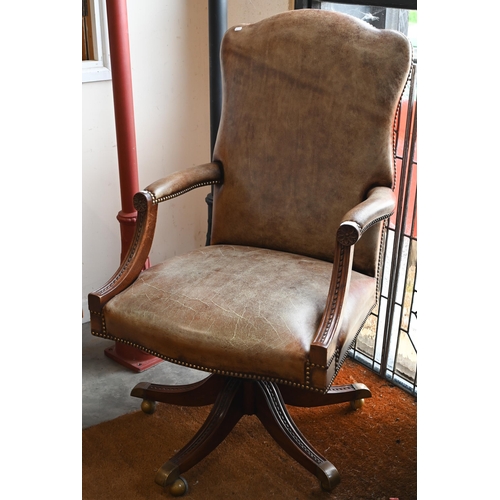 59 - A mahogany framed swivel director's/office chair with studded aged vinyl/leatherette upholstery