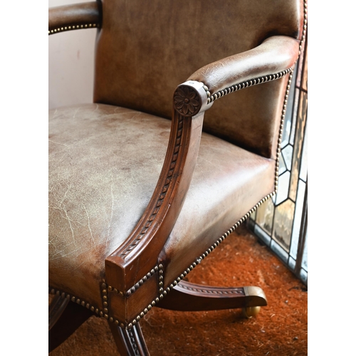 59 - A mahogany framed swivel director's/office chair with studded aged vinyl/leatherette upholstery