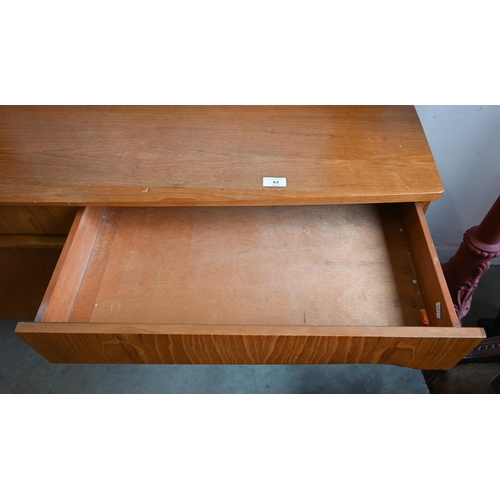 63 - A Mid-Century Remploy teak bowfront sideboard, circa 1960s, central drop front cocktail cabinet betw... 