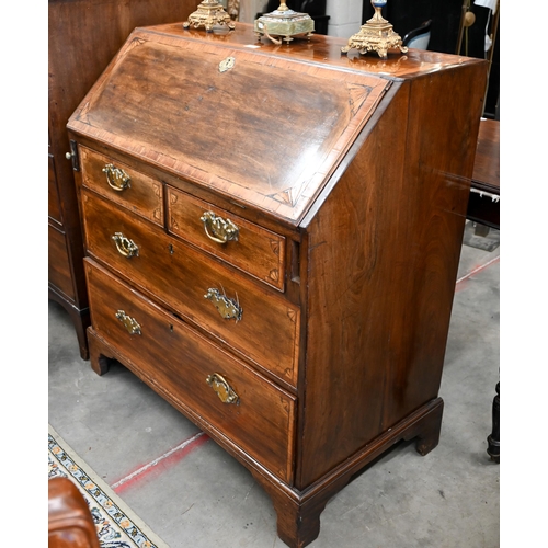 66 - A Georgian mahogany inlaid bureau with fitted interior, two short and two long drawers on bracket fe... 