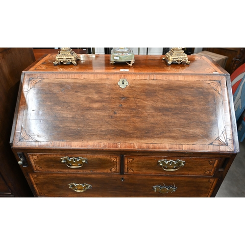 66 - A Georgian mahogany inlaid bureau with fitted interior, two short and two long drawers on bracket fe... 