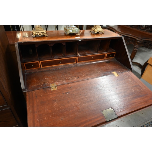 66 - A Georgian mahogany inlaid bureau with fitted interior, two short and two long drawers on bracket fe... 