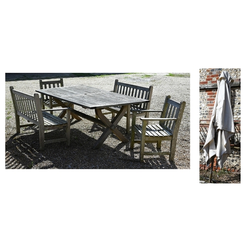 7 - A weathered teak patio dining set comprising dining table on cross-trestle supports, 214 x 108 x 72 ... 