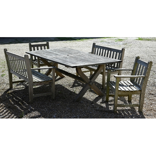 7 - A weathered teak patio dining set comprising dining table on cross-trestle supports, 214 x 108 x 72 ... 