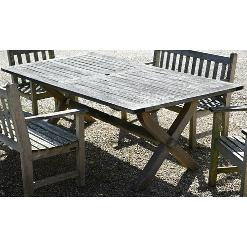 7 - A weathered teak patio dining set comprising dining table on cross-trestle supports, 214 x 108 x 72 ... 