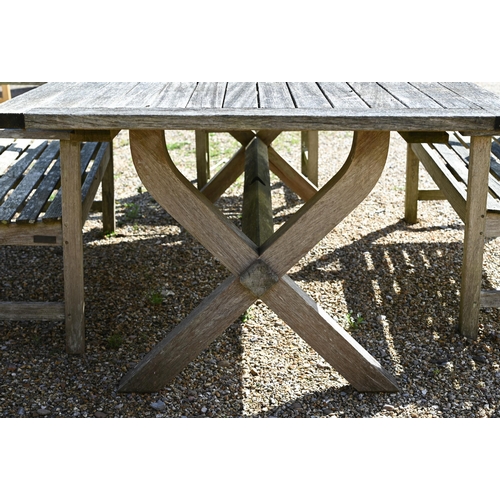 7 - A weathered teak patio dining set comprising dining table on cross-trestle supports, 214 x 108 x 72 ... 