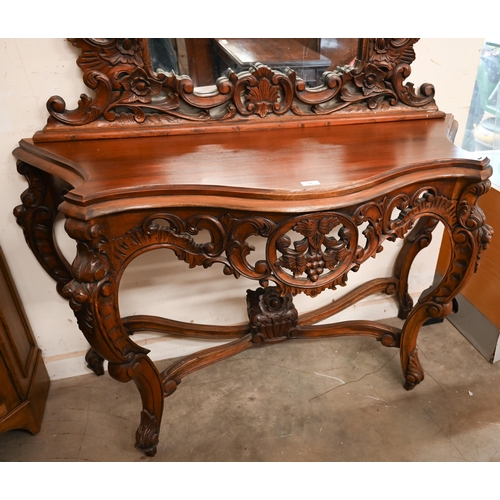 84 - A Rococo style carved hardwood serpentine front console table and mirror, 138 x 50 x 234 cm h