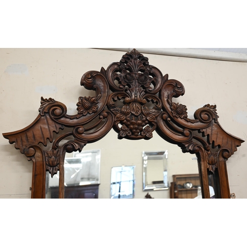 84 - A Rococo style carved hardwood serpentine front console table and mirror, 138 x 50 x 234 cm h