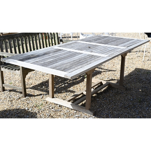 9 - An extending slatted teak garden dining table with draw-leaf top accepting optional central leaf 180... 