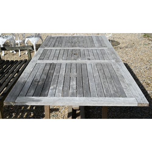 9 - An extending slatted teak garden dining table with draw-leaf top accepting optional central leaf 180... 