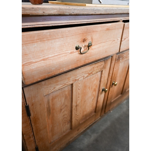 90 - Antique pine dresser base with two drawers over panelled cupboard doors (one loose handle, in drawer... 